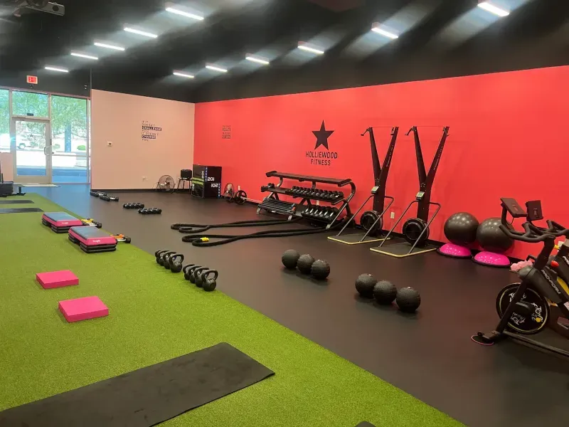 Turf training area with kettlebells and step platforms at Holliewood Fitness